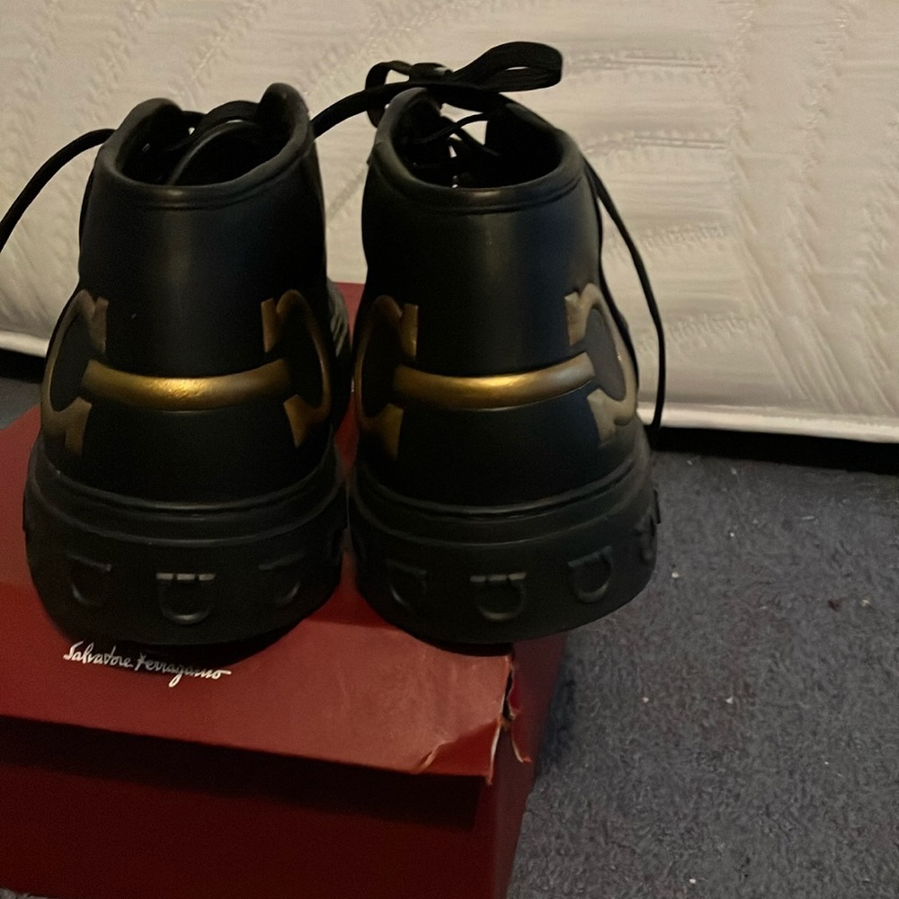 Black leather lace up ankle sneakers. Still in Good condition.